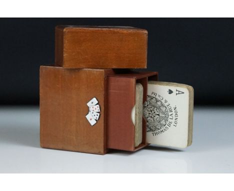 Austrian wooden playing cards box with applied enamel playing cards motif, 10.5cm high, containing two sets of Thomas De La R