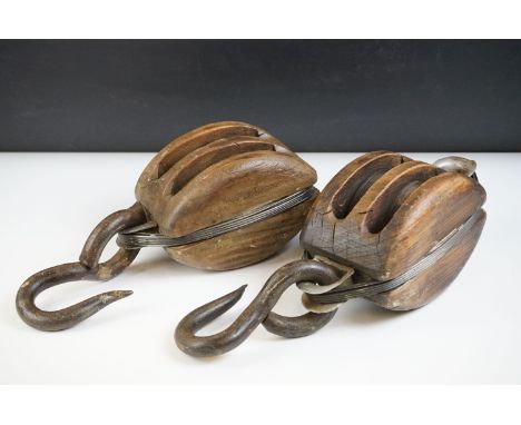 Pair of antique wooden ships pulley blocks with iron hooks and twin cast iron roller wheels, largest approx 35cm long 