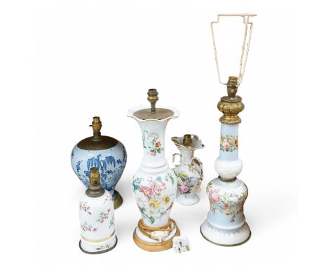 Four 19th century Paris porcelain lamp bases and an 18th century Delft lamp base, largest 53cm high including the fitting. Co