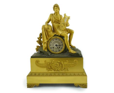 A 19th century French bronze and ormolu mantel clock surmounted with a figure of Apollo holding a lyre, with silvered Roman d