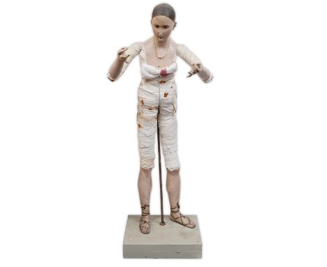 A 19th century French carved and painted wood female mannequin, with fabric covered arms and body, standing upon a painted wo