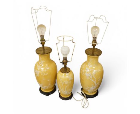 A garniture of three Chinese yellow ground lamp bases, pair 40cm high. Condition - fair One larger vase neck repaired, clearl