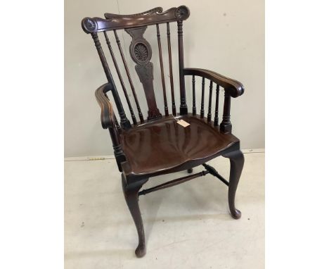 An early 20th century mahogany elbow chair with saddle seat, width 56cm, depth 45cm, height 98cm, and a later beech Windsor e