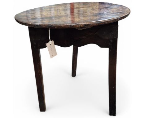An early 19th century fruitwood cricket table, diameter 57cm, height 63cm. Condition - fair Splits to the top. Several chips,