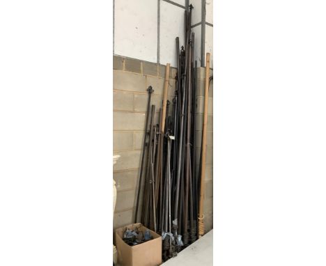 A large quantity of assorted iron and wood curtain poles with rings and fixings. Condition - fair