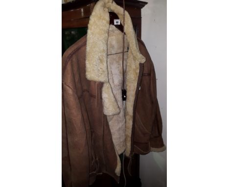 A Gentleman's Brown Suede Flying Jacket; with sheepskin lining and a United States Army badge to the front.