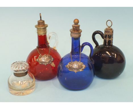 Three 19th century coloured glass bottles of flattened flask form with plated mounts and cork stoppers, blue, red and amethys