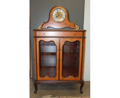 A reproduction wood effect 'marquetry' mantel clock with gilt and enamel dial and gilt metal mounts, 37cm high, 62cm wide, on