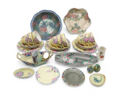 A MAY WILSON HAND PAINTED TEA SET comprising six cups, saucers and plates, each painted with pink and lilac flowers and butte