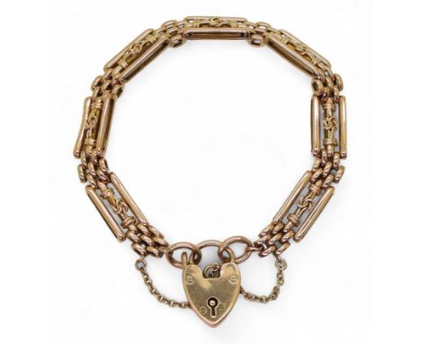 LOVERS KNOT BRACELET a 9ct rose gold gate bracelet with a lovers knot detail to the links, and a heart shaped clasp. Length 1