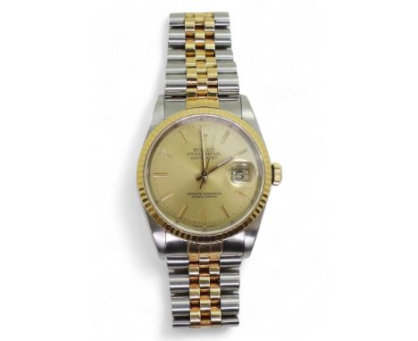 A ROLEX OYSTER PERPETUAL DATEJUST in two tone stainless steel and gold, with gold coloured dial, baton numerals and hands, wi