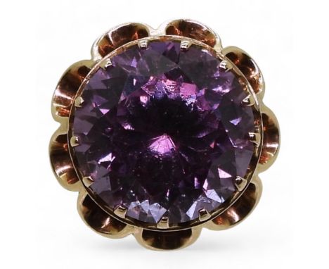 A 14K DRESS RING set with a faux colour change amethyst, in a decorative scalloped setting. Finger size O1/2, weight 9gms Con