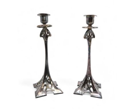 A PAIR OF WMF ART NOUVEAU SILVER PLATED CANDLESTICKS shape no 92, with openwork foliate design, with stamped marks and moulde