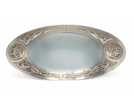 MARGARET GILMOUR (1860-1942) A Glasgow School white metal mirror, of oval shape with Celtic knotwork roundels and interlacing