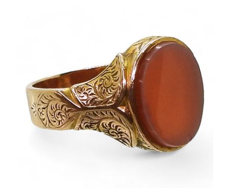 A VINTAGE SIGNET RING made in 15ct gold hallmarked Birmingham 1882, with foliate engraving and set with a carnelian seal ston