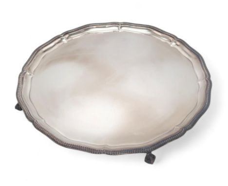 AN ELIZABETH II SILVER SALVER by Mappin &amp; Webb, Sheffield 1975, of lobed form, with a reeded rim, on four ball and claw f