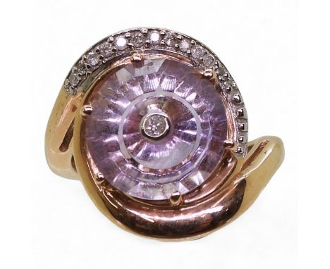 A GLEN LEHRER TORUS RING made in 10k rose gold and set with a torus cut amethyst with a central diamond and an arc of diamond