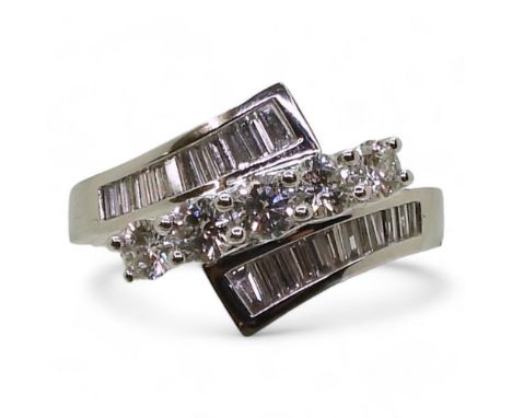 A SUBSTANTIAL DIAMOND DRESS RING set with estimated approx 1ct of brilliant cut and baguette cut diamonds. The good quality d