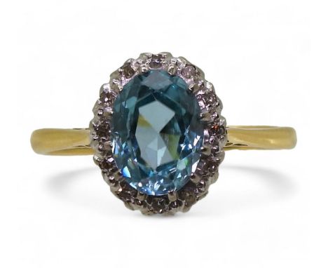 A BLUE ZIRCON &amp; DIAMOND RING in 18ct yellow and white gold scroll galleried mount, the zircon measures 8mm x 6mm x 3.7mm 