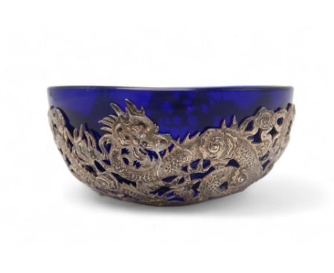 A CHINESE EXPORT SILVER MOUNTED FINGER BOWL  Cast with dragons surrounding a blue glass bowl, makers stamp,MT,12cm diameter C