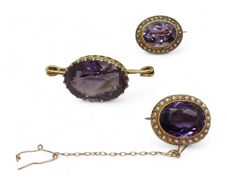 THREE AMETHYST BROOCHES the darkest amethyst is 15.5mm x 12mm, mounted in 15ct gold and surrounded with split pearls, weight 