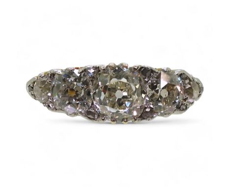 A SUBSTANTIAL FIVE STONE RING the classic scroll mount, set with five old cut diamonds with an estimated approximate diamond 