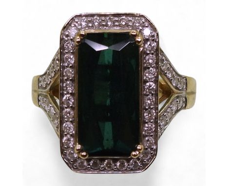 A TOURMALINE AND DIAMOND RING the GemsTV ring, is set with a teal green octagonal tourmaline of approx 14mm x 7mm, surrounded