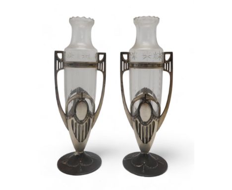 A PAIR OF WMF SILVER PLATED TWIN HANDLED VASES of classical design with swags of laurel and oval medallion, each with a clear