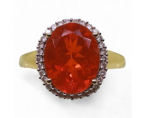 A FIRE OPAL &amp; DIAMOND RING in a 18k gold galleried mount, finger size L1/2, weight 4.7gms Condition Report:Available upon