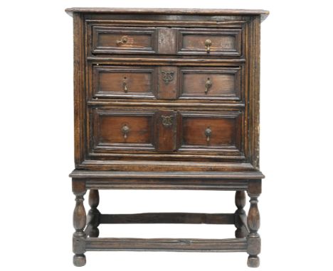 A 17TH CENTURY OAK JACOBEAN CHEST ON STAND&nbsp; with three graduating drawers on base with turned supports joined by stretch