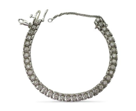 A 14K DIAMOND BRACELET the mount in 14k white gold, set with estimated approx 1.73cts of brilliant cut diamonds in illusion s