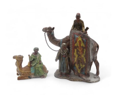 A COLD PAINTED SPELTER TABLE STRIKER modelled in the form of carpet sellers and a camel, together with an inkwell in the form