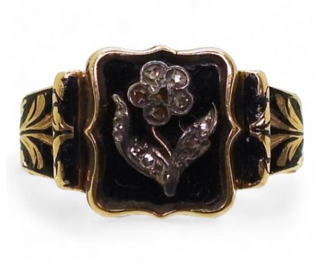 A MOURNING RING made in bright yellow metal, the black enamel band inscribed 'In Memory Of' with a diamond set 'Forget-me-not