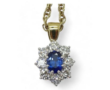 A SAPPHIRE &amp; DIAMOND PENDANT mounted in bright yellow and white metal the classic flower cluster pendant is set with a 7.