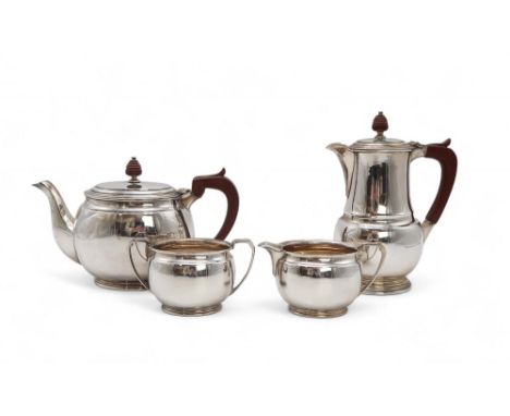 AN ELIZABETH II FOUR PIECE SILVER TEA SERVICE by Roberts &amp; Belk, Sheffield 1962, of baluster form, with concave band, wit