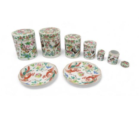 A PAIR OF CANTON FAMILLE ROSE JARS AND COVERS&nbsp; Painted with exotic birds and flowers, 12.5cm high and two saucers, 14cm 