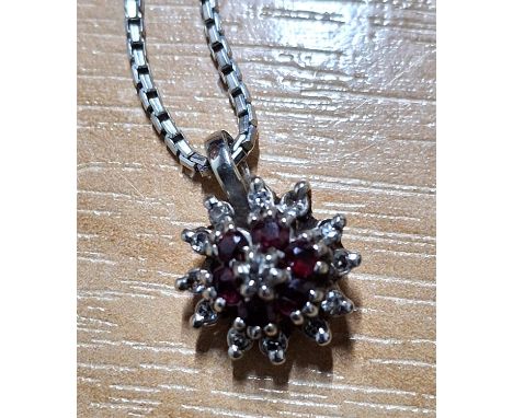 Diamond and ruby cluster pendant on a 9ct white gold chain5.3g gross  18cm chain