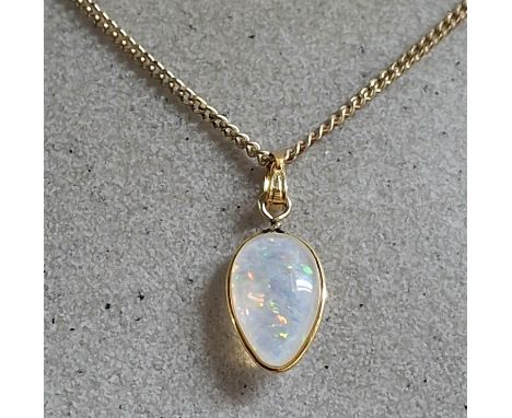 Large whole Opal pendant in teardrop form set in 9ct yellow gold and comes on a hallmarked 9ct yellow gold fine chain,4.1 gra
