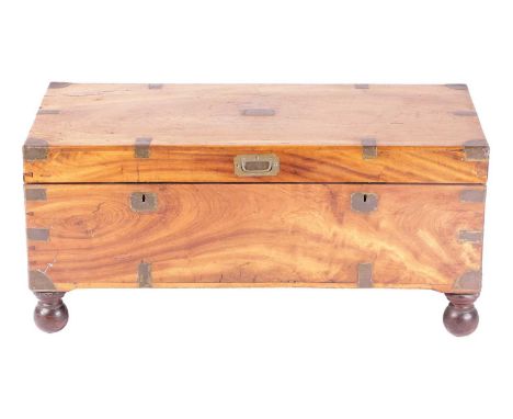 A Victorian brass-bound teakwood campaign trunk with a hinged cover fitted sunken folding bale handle and black iron packet h