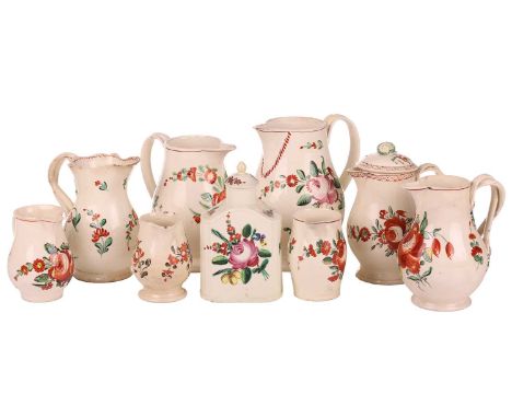 Nine pieces of late eighteenth-century/early nineteenth-century creamware jugs, florally decorated, probably Leeds, the talle