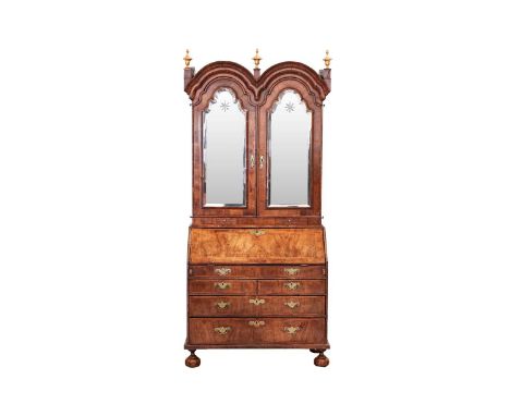 A composite Queen Anne figured walnut double dome bureau bookcase with cross grain moulding throughout the doors with a pair 