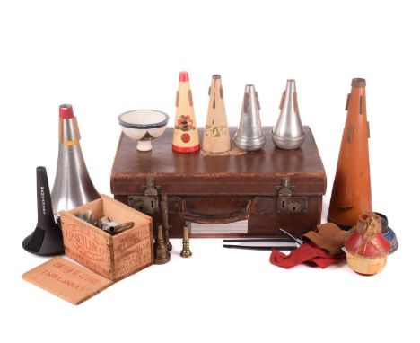 A vintage brown leather travelling case, containing a quantity of musical instrument accessories, comprising nine assorted mu