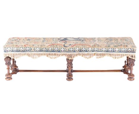 A late seventeenth-century style walnut long hearth stool, early twentieth-century with seventeenth-century Flemish tapestry 
