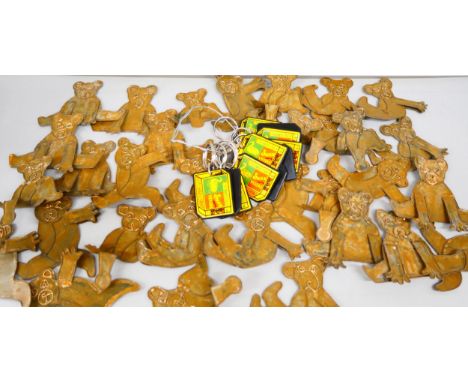 Thirty-two tin-plate Teddy bear ornaments and eleven Swan Vestas key rings