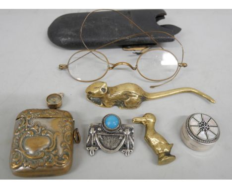 An Egyptian silver and mother of pearl inlaid pill box, a vesta case, novelty brass duck pipe tamper, a yellow metal compass 