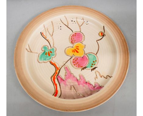 A Clarice Cliff plate with hand painted detail, 25cm