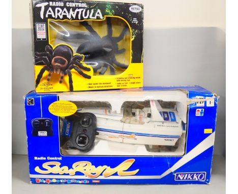 A Nikki radio control Sea Ray boat and a remote control toy Tarantula, both boxed