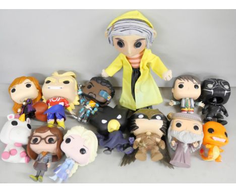 A collection of Funko, including one Bobblehead, a Coraline character doll and a Mega Bloks Need for Speed Porsche