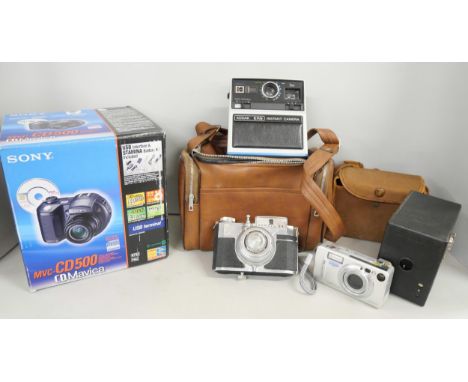 A collection of cameras, including Kodak Brownie and Kodak EK6 Instant, Sony CD Mavica, etc.