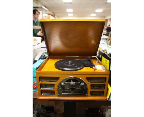 A MODERN COMBINATION RADIO/ RECORD / CD PLAYER 